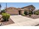 Well-maintained single-story home with a two-car garage and neatly landscaped front yard with desert landscaping at 2177 W Agrarian Hills Dr, San Tan Valley, AZ 85144