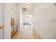 Bright hallway with tiled flooring leading to a living area, showcasing a clean and open design at 2177 W Agrarian Hills Dr, San Tan Valley, AZ 85144