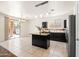 Modern kitchen with dark cabinets, a central island, stainless steel appliances and lots of natural light at 2177 W Agrarian Hills Dr, San Tan Valley, AZ 85144