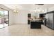 Spacious kitchen featuring dark cabinets, granite countertops, and stainless steel appliances for modern cooking at 2177 W Agrarian Hills Dr, San Tan Valley, AZ 85144