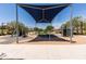 Well-maintained community playground with various play structures under a shade and paved access at 2177 W Agrarian Hills Dr, San Tan Valley, AZ 85144