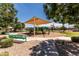 Community playground featuring sunshade, various play structures, benches and gravel areas at 2177 W Agrarian Hills Dr, San Tan Valley, AZ 85144