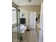 Bright bathroom with a glass-enclosed tub, tile floors, and a vanity at 2461 W Muirfield Dr, Anthem, AZ 85086
