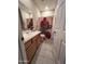 Functional bathroom with a vanity, neutral walls, and tile flooring at 2461 W Muirfield Dr, Anthem, AZ 85086