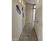 Well-lit hallway with tiled floors and decorative leaf wall art leads to other rooms at 2461 W Muirfield Dr, Anthem, AZ 85086