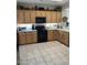 Well-appointed kitchen featuring ample cabinet space and modern appliances on tile flooring at 2461 W Muirfield Dr, Anthem, AZ 85086