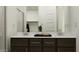 Contemporary bathroom featuring a double vanity, sleek mirrors, and modern fixtures at 25140 N 174Th Ave, Surprise, AZ 85387