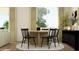 Cozy dining area with a round table, seating for four, and a contemporary light fixture at 25140 N 174Th Ave, Surprise, AZ 85387