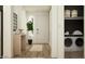 Welcoming entryway with a console table, laundry area, and hardwood floors at 25140 N 174Th Ave, Surprise, AZ 85387