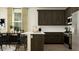 Modern kitchen equipped with stainless steel appliances, dark wood cabinets, and a breakfast bar at 25140 N 174Th Ave, Surprise, AZ 85387