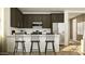 Charming kitchen featuring a breakfast bar, stainless steel appliances, and dark cabinets at 25140 N 174Th Ave, Surprise, AZ 85387