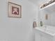 Fresh bathroom featuring white cabinets, a sleek sink, vanity lights and contemporary decor for a modern, clean feel at 2812 E Clarendon Ave, Phoenix, AZ 85016
