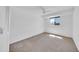 Bright bedroom has neutral carpet, white walls, a window, and ceiling fan at 2812 E Clarendon Ave, Phoenix, AZ 85016