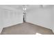 This bedroom has neutral carpet, a ceiling fan, spacious closet, and bright white walls at 2812 E Clarendon Ave, Phoenix, AZ 85016