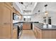 Updated kitchen boasting granite countertops, modern appliances, ample cabinets, and stylish pendant lighting at 2812 E Clarendon Ave, Phoenix, AZ 85016