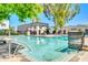 Community pool featuring inviting blue water, plenty of seating, and shady umbrellas at 2812 E Clarendon Ave, Phoenix, AZ 85016