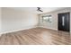 A light-filled bedroom featuring wood-look flooring, a ceiling fan, and a window at 2941 W Michigan Ave, Phoenix, AZ 85053