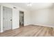 An empty room with hardwood floors and attached bathroom. A large door and closet are also present at 2941 W Michigan Ave, Phoenix, AZ 85053