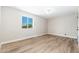 A bright empty bedroom features hardwood floors, baseboards, and a view from the window at 2941 W Michigan Ave, Phoenix, AZ 85053
