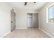 Carpeted bedroom with closet, neutral walls and bright window at 2941 W Michigan Ave, Phoenix, AZ 85053