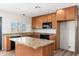 Well-lit kitchen showcasing granite counters, stainless steel appliances, and a center island at 2941 W Michigan Ave, Phoenix, AZ 85053
