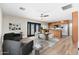 Open-concept living space with a dining area, stylish furniture, and wood-look flooring at 2941 W Michigan Ave, Phoenix, AZ 85053