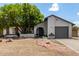 Inviting single-story home with mature tree, desert landscaping, and brick pathway to front door at 3039 W Ross Ave, Phoenix, AZ 85027