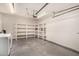 Garage featuring laundry, storage shelves, and ample space for parking vehicles or additional storage at 3039 W Ross Ave, Phoenix, AZ 85027