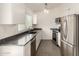 Modern kitchen featuring stainless steel appliances, granite countertops, and white cabinets at 3039 W Ross Ave, Phoenix, AZ 85027