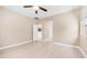 Bedroom with wood-look floors, ceiling fan, and view into the kitchen at 3439 W Darien Way, Phoenix, AZ 85086