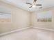 Bedroom with ceiling fan, wood-look floors, and windows overlooking the exterior at 3439 W Darien Way, Phoenix, AZ 85086