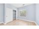 Bedroom with wood-look floors, a closet, and a window at 3439 W Darien Way, Phoenix, AZ 85086