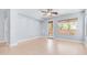 Spacious bedroom with wood-look floors, ceiling fan, and access to the outdoors at 3439 W Darien Way, Phoenix, AZ 85086