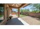 Covered patio area with a ceiling fan, overlooking a backyard with desert landscaping at 3439 W Darien Way, Phoenix, AZ 85086