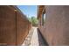 Paver walkway along the side of the house with stucco walls and desert landscaping at 3439 W Darien Way, Phoenix, AZ 85086