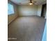 Carpeted bedroom with a ceiling fan and an adjacent bathroom at 40504 N Las Praderas St, San Tan Valley, AZ 85140