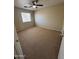 Spacious carpeted bedroom with a ceiling fan and a window at 40504 N Las Praderas St, San Tan Valley, AZ 85140