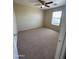 Cozy carpeted bedroom featuring a ceiling fan and window at 40504 N Las Praderas St, San Tan Valley, AZ 85140