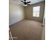 Bright bedroom with a ceiling fan, neutral walls, and plush carpeting at 40504 N Las Praderas St, San Tan Valley, AZ 85140