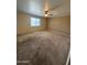 Spacious bedroom with neutral walls and carpeting, equipped with a ceiling fan at 40504 N Las Praderas St, San Tan Valley, AZ 85140
