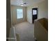 Carpeted hallway with a window, stairs and neutral walls at 40504 N Las Praderas St, San Tan Valley, AZ 85140