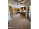 Spacious kitchen with wooden cabinets, tile flooring, and modern black appliances at 40504 N Las Praderas St, San Tan Valley, AZ 85140