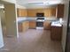 Kitchen with light wood cabinets, tile floor and white appliances at 40504 N Las Praderas St, San Tan Valley, AZ 85140
