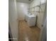 Well-lit laundry room with washer, dryer, and wire shelving at 40504 N Las Praderas St, San Tan Valley, AZ 85140
