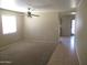 Neutral living room with carpet and tile and a view into the kitchen at 40504 N Las Praderas St, San Tan Valley, AZ 85140