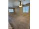Bright living room with two windows, a ceiling fan, and wall-to-wall carpeting at 40504 N Las Praderas St, San Tan Valley, AZ 85140