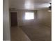 The living room features neutral paint, carpet, and a window at 40504 N Las Praderas St, San Tan Valley, AZ 85140