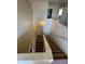 Carpeted staircase featuring a light fixture and white railing, leading to upper floors at 40504 N Las Praderas St, San Tan Valley, AZ 85140