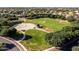 Wide open park space featuring a basketball court, covered shelter, and mature trees at 4140 E Claxton Ave, Gilbert, AZ 85297