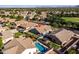 An aerial view shows the backyard layout of this home and the surrounding neighborhood pools at 4140 E Claxton Ave, Gilbert, AZ 85297